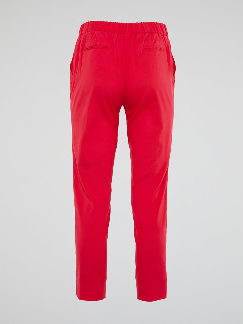 Unleash your inner wild side with the vibrant red hue of these Roberto Cavalli elasticated waist pants, designed to make a bold statement wherever you go. The luxurious fabric and impeccable tailoring ensure a flattering fit that's both comfortable and stylish, perfect for adding a touch of Italian glamour to your wardrobe. Elevate your everyday look with these eye-catching pants that exude confidence, sophistication, and a touch of playful eccentricity.