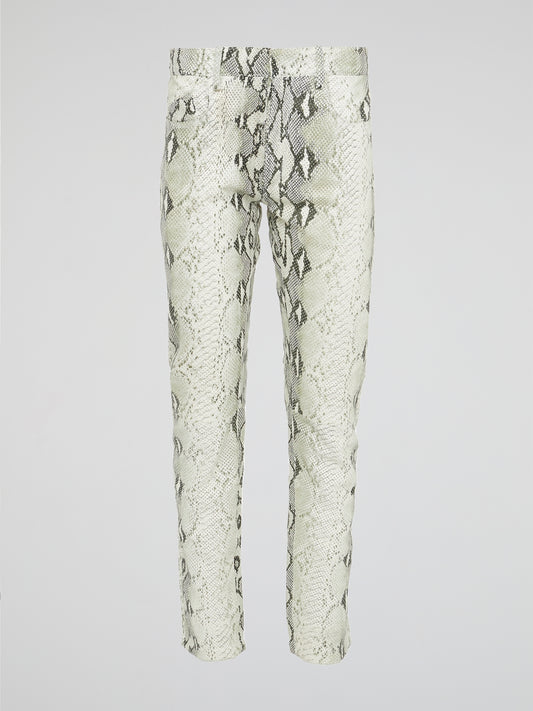 Infuse your wardrobe with a touch of wild sophistication with these snake print skinny trousers from Roberto Cavalli. Crafted from luxurious fabric, these statement pants will elevate any outfit from basic to bold in an instant. Step out in style and turn heads wherever you go with these modern, edgy trousers that exude confidence and glamour.