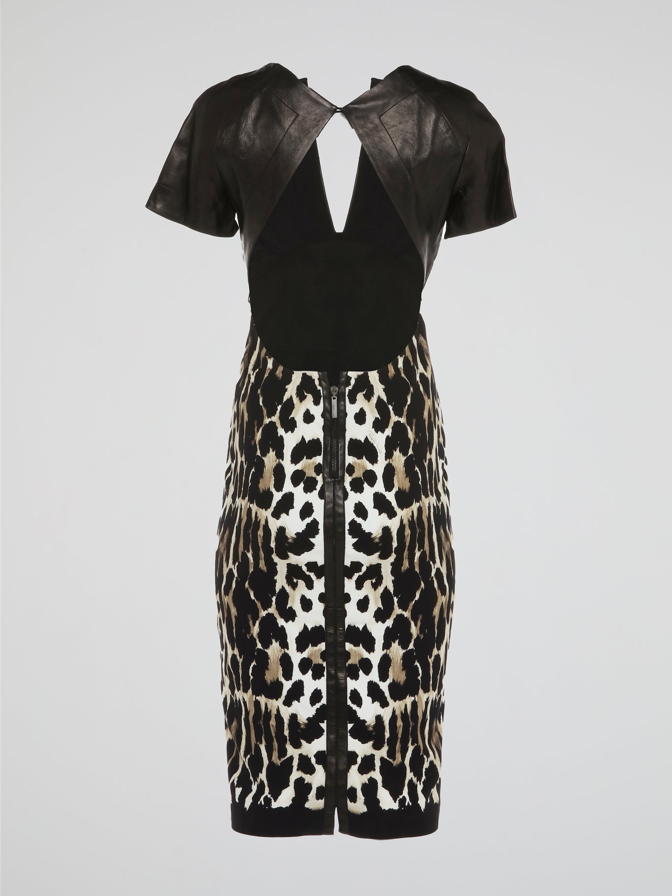 Make a fierce fashion statement with this Animal Print Leather Panel Dress by Roberto Cavalli. Unleash your inner wild side with its daring leopard print design, combined with luxurious leather panels that exude confidence and allure. This stunning dress combines elegance and edginess, making it the perfect choice for any glamorous occasion.