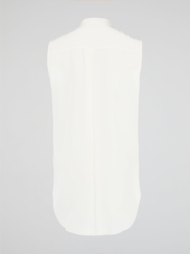 Unleash your fierce, fashion-forward side with the White Studded Sleeveless Shirt by Akris Punto. Crafted with meticulous attention to detail, this statement piece is adorned with intricately placed studs that exude edgy sophistication. Perfectly blending poise and rebellious spirit, this sleeveless shirt is a captivating must-have for those seeking to redefine their style game.