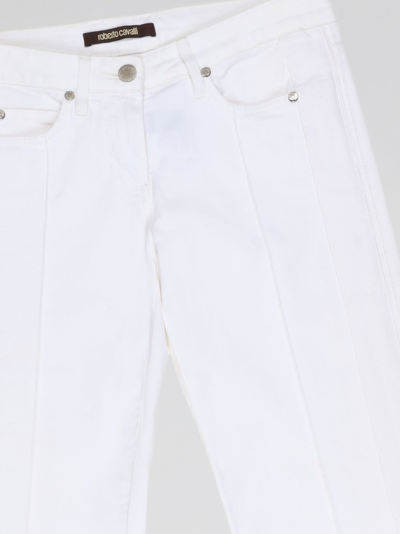 Step into fashion-forward elegance with these White Flared Jeans from renowned designer Roberto Cavalli. Crafted with meticulous attention to detail, these jeans feature a flattering high waistline and a mesmerizing flared silhouette that effortlessly elongates your legs. The pure white hue adds a touch of sophistication, making them the perfect statement piece for any occasion.