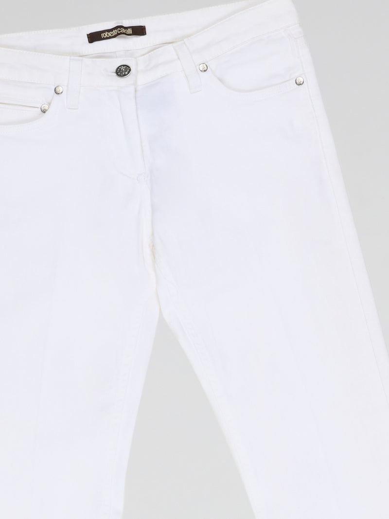 Step into fashion-forward elegance with these White Flared Jeans from renowned designer Roberto Cavalli. Crafted with meticulous attention to detail, these jeans feature a flattering high waistline and a mesmerizing flared silhouette that effortlessly elongates your legs. The pure white hue adds a touch of sophistication, making them the perfect statement piece for any occasion.