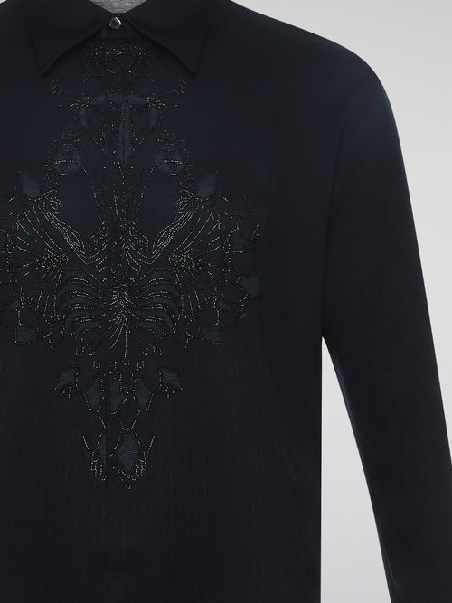 Step into the realm of effortless elegance with the captivating Black Embroidered Shirt by Roberto Cavalli. Adorned with intricate embroidery and delicate lace details, this shirt is a mesmerizing fusion of sophistication and sensuality. Elevate your style with this statement piece that exudes an air of mystique and timeless allure.