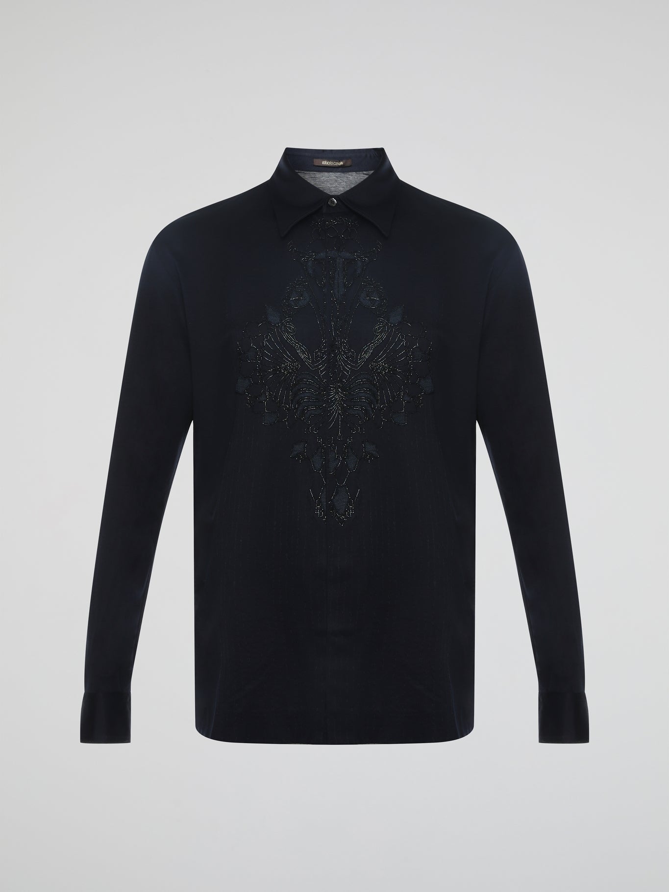 Step into the realm of effortless elegance with the captivating Black Embroidered Shirt by Roberto Cavalli. Adorned with intricate embroidery and delicate lace details, this shirt is a mesmerizing fusion of sophistication and sensuality. Elevate your style with this statement piece that exudes an air of mystique and timeless allure.