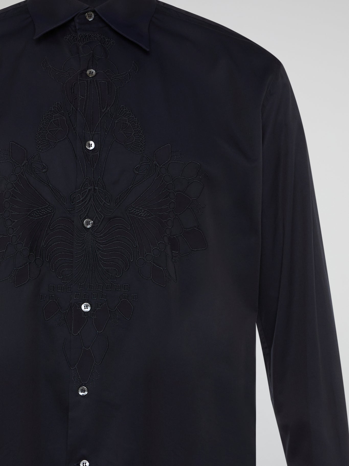 Step into the realm of effortless elegance with the captivating Black Embroidered Shirt by Roberto Cavalli. Adorned with intricate embroidery and delicate lace details, this shirt is a mesmerizing fusion of sophistication and sensuality. Elevate your style with this statement piece that exudes an air of mystique and timeless allure.