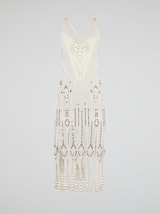 Step out in style in this stunning White Embroidered Fringe Dress from iconic designer Roberto Cavalli. The intricate embroidery detailing and playful fringe trim add a touch of bohemian elegance to this timeless piece. Whether you're hitting the beach or attending a summer soirée, this dress is sure to turn heads and make a statement.