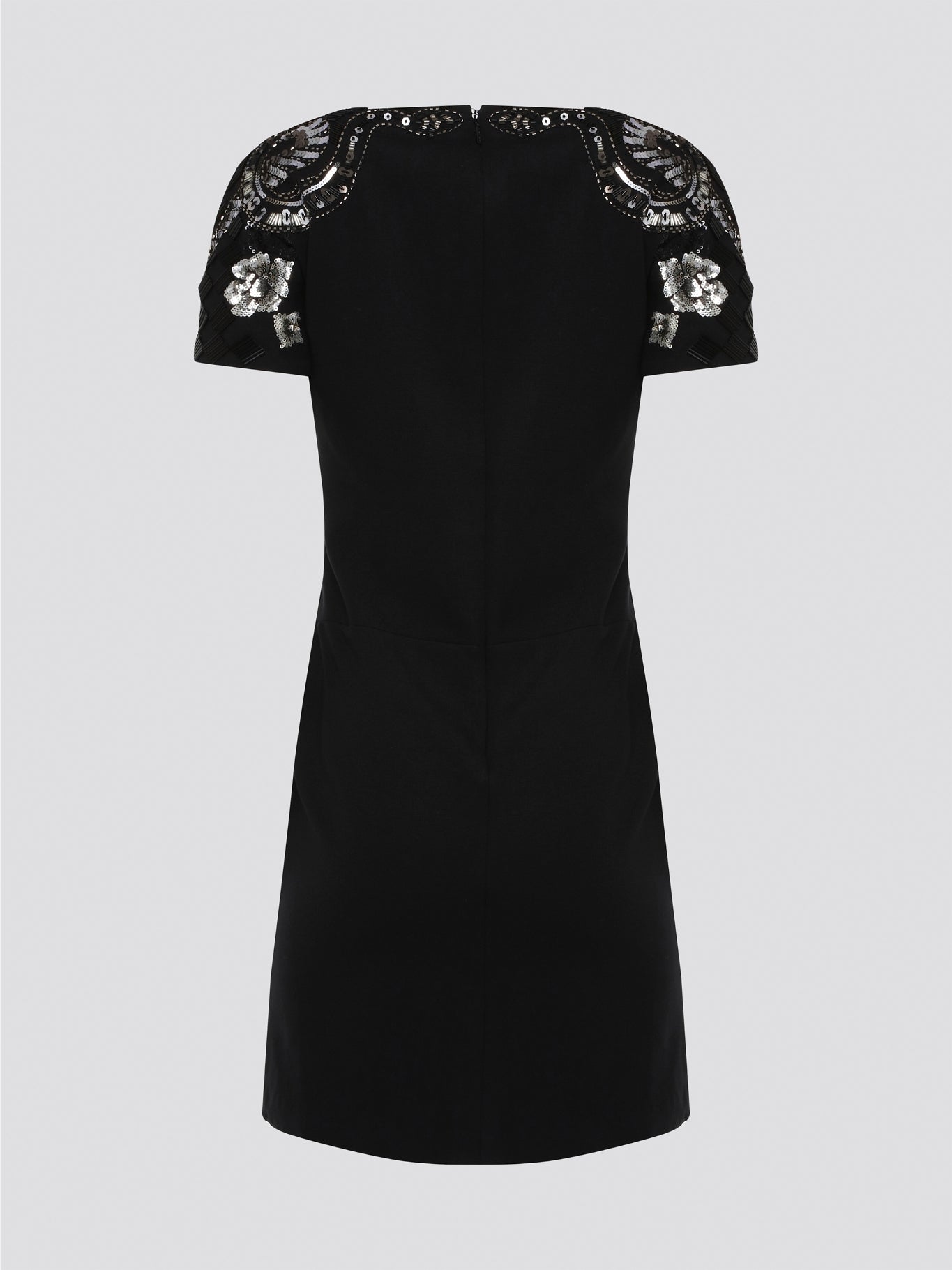 Step out in style and sophistication with our Black Embellished Plunge Dress by Roberto Cavalli. This stunning piece features intricate beadwork and shimmering embellishments that are sure to turn heads. The plunging neckline adds a touch of allure, making it the perfect choice for your next special occasion. Elevate your wardrobe with this show-stopping dress that exudes luxury and glamour.