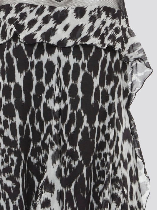 Unleash your wild side with this fierce Leopard Print Chiffon Top by Roberto Cavalli. Made from luxurious chiffon fabric, this top oozes elegance and confidence. Pair it with sleek black pants for a day-to-night look that is sure to turn heads.