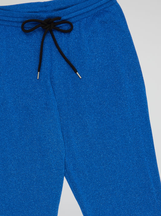 Elevate your casual style with these effortlessly chic Blue Drawstring Cuffed Pants by Markus Lupfer. Made from premium materials, these pants feature a flattering drawstring waist and trendy cuffed ankles for a modern twist on a classic silhouette. Perfect for a day out or a cozy night in, these versatile pants will quickly become a wardrobe staple.